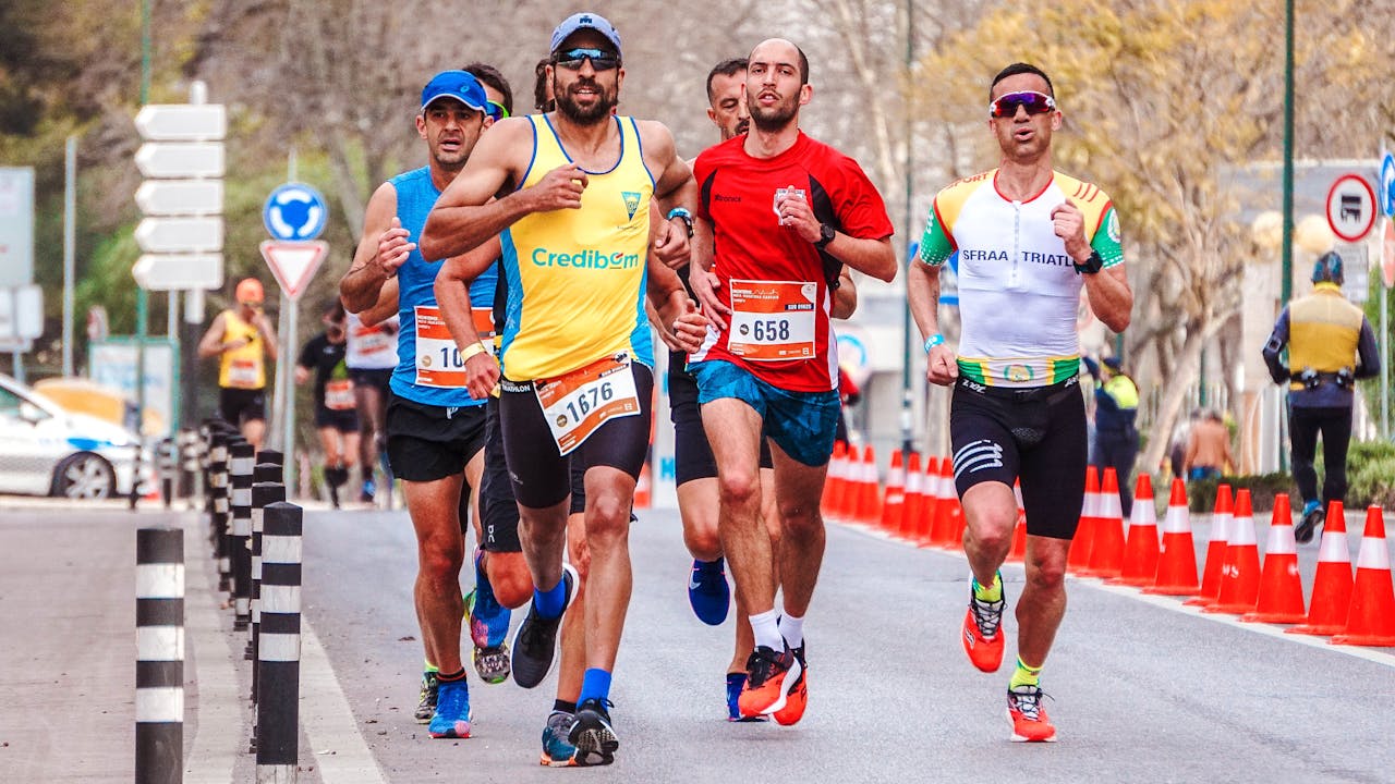 Dynamic scene of a group of male runners competing in an outdoor marathon.